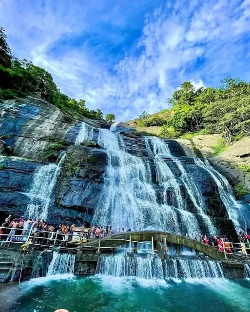Cascading water and green hills at Courtallam Falls